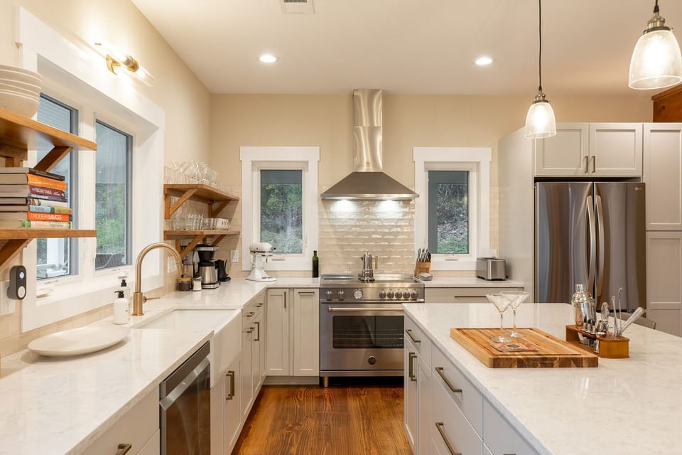 Beautiful white countertops and spotless stainless steel appliances. 