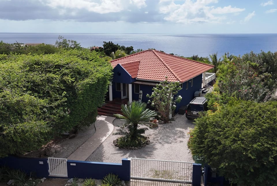 Entrance Dolphin house 621. Spacious garden with mature trees.