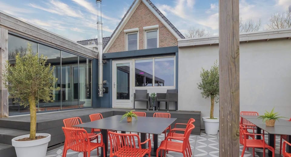 The spacious flexible patio is made for gathering, with outdoor dining tables, comfortable seating, and seamless access to the villa, covered terrace, and outdoor kitchen—perfect for meals, celebrations, and relaxing together. 