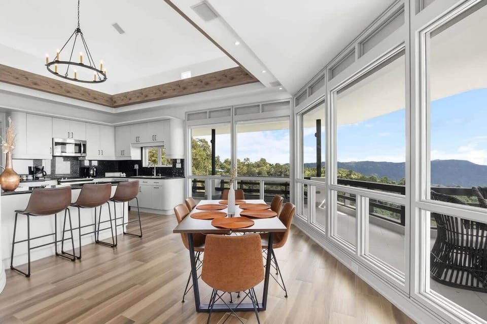 The kitchen and dining area offer panoramic views of the mountains.