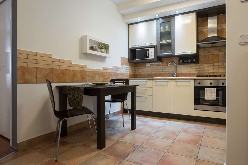 Fully equipped modern kitchen with dining table.