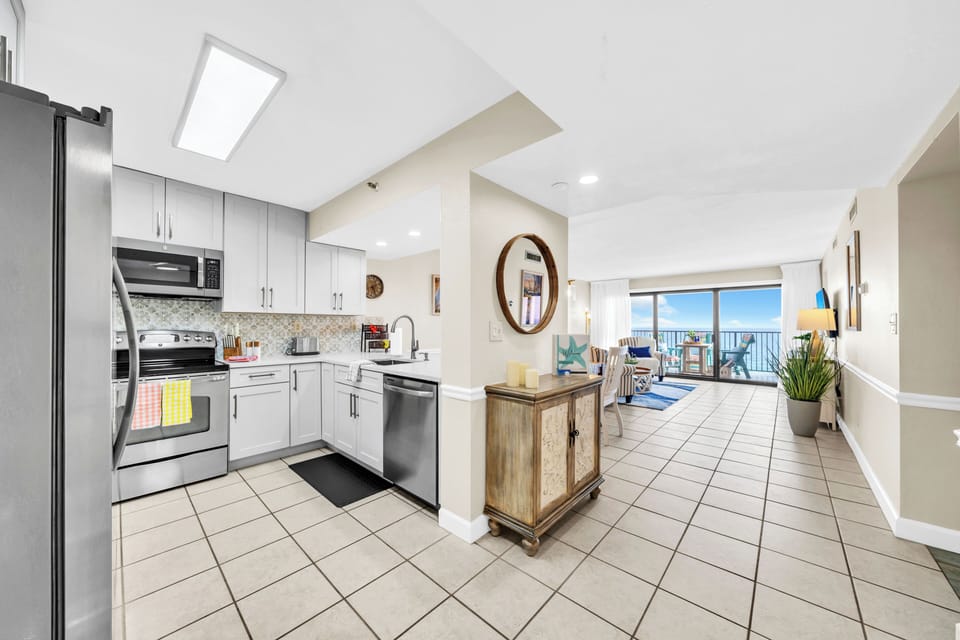 Your spacious kitchen flows seamlessly into the living area, where natural light streams through skylights and gulf views await through sliding doors.