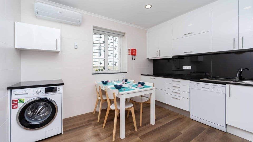 Kitchen equipped with a dishwasher and washing machine along with an AC unit. #comfort #kitchen