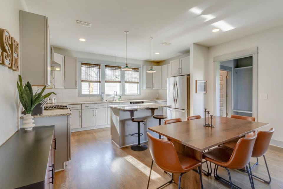 The dining area with a table and chairs is perfectly sized for group meals and conversation.