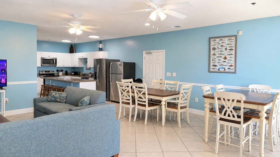 Bright dining space with seating for the full group, coastal light throughout.