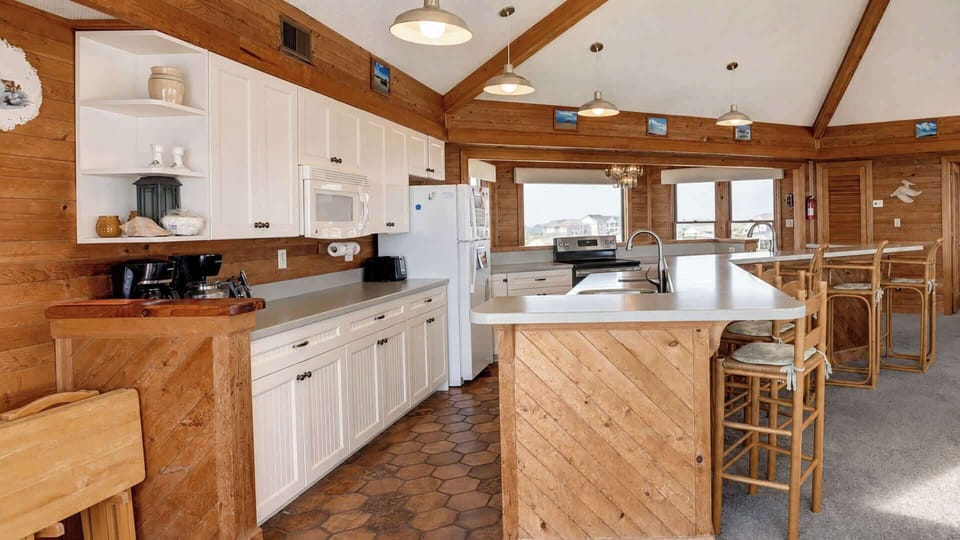 The kitchen opens toward the living and dining spaces.