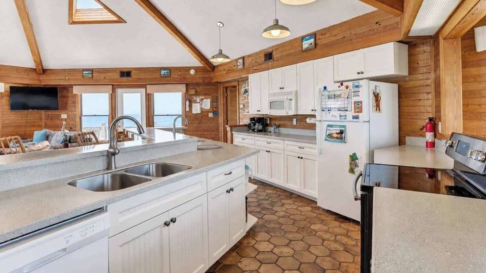 A gourmet kitchen with granite counters and full-size appliances.