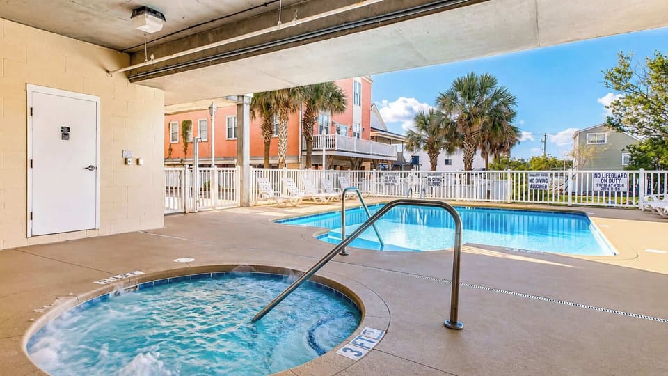 A shared pool and hot tub, steps from the building.