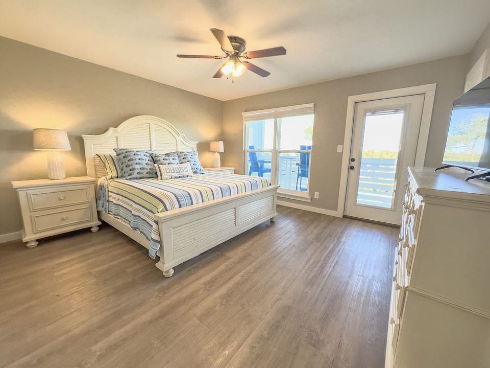 Main bedroom with king bed and balcony overlooking the lake