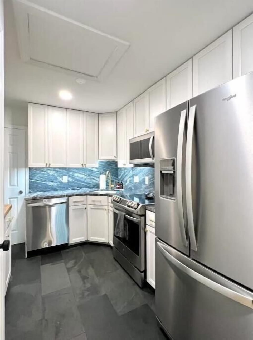The kitchen includes a full-sized refrigerator with integral water dispener.