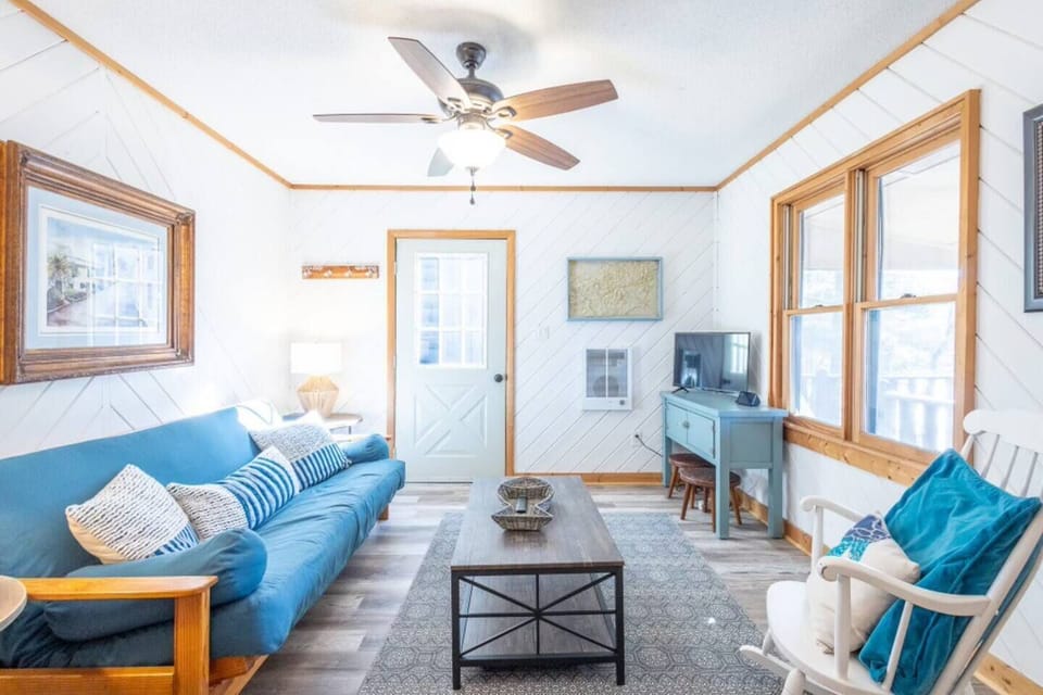 Relax in the cabin's cozy living area, complete with a futon for extra sleeping, views of the lake and a smart tv.