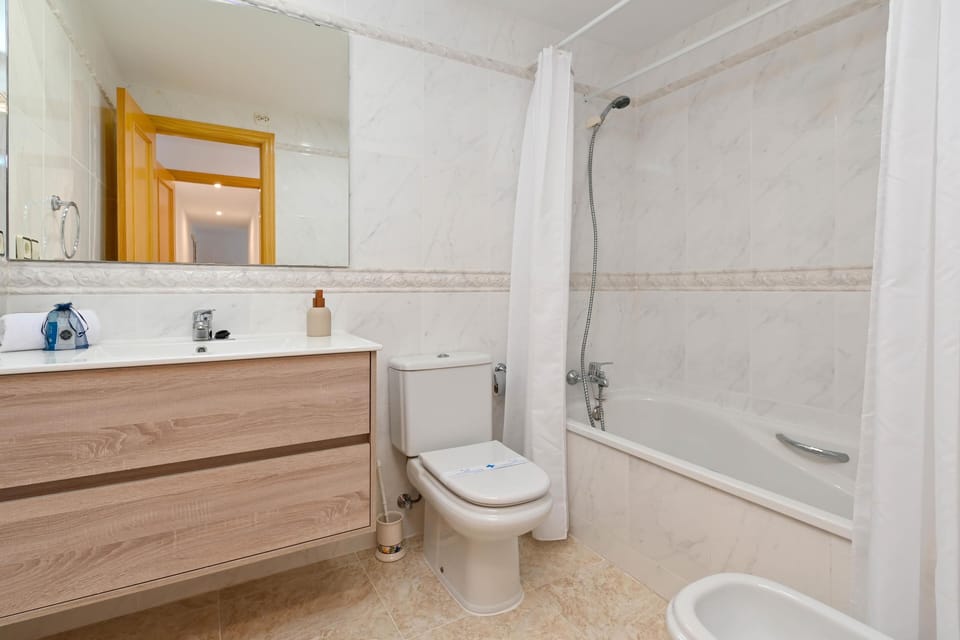 Bathroom with bath and shower