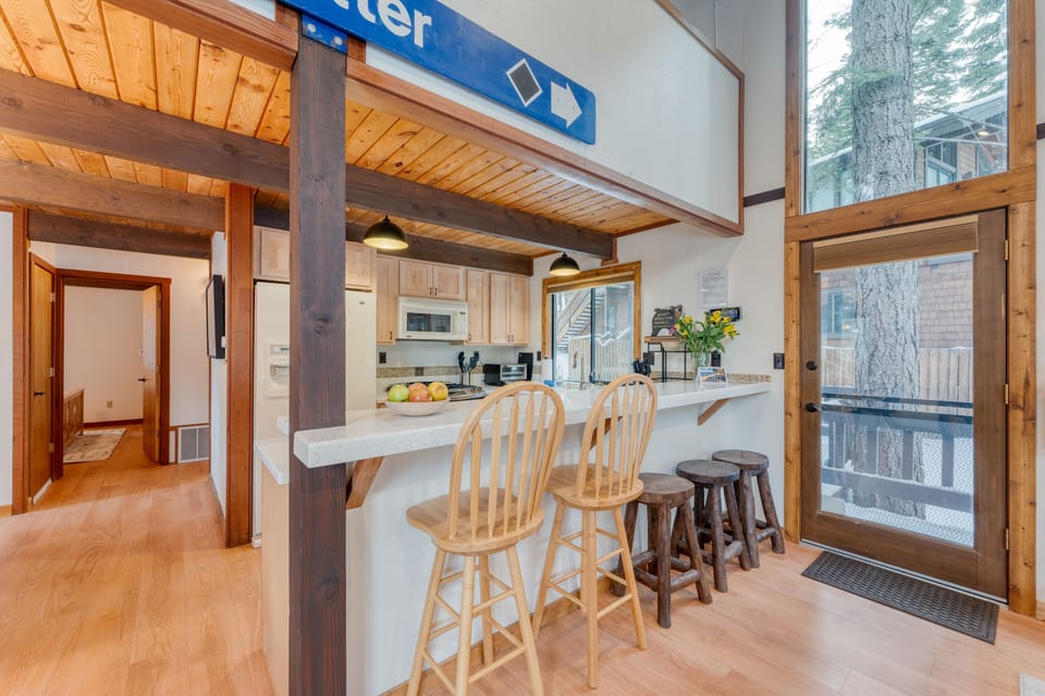 Kitchen counter features barstool seating.