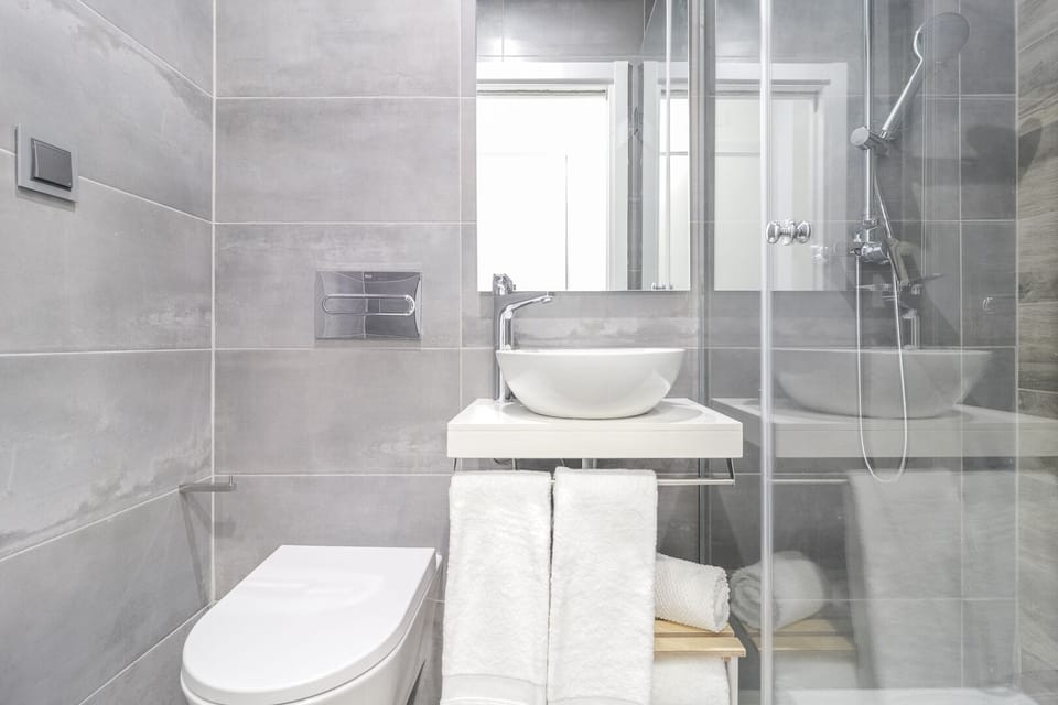 Shower, hair dryer, slippers, towels