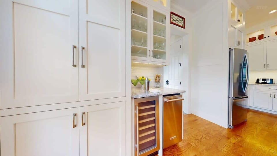 There's a bar area attached to the kitchen area, complete with a wine fridge and lots of stemware.