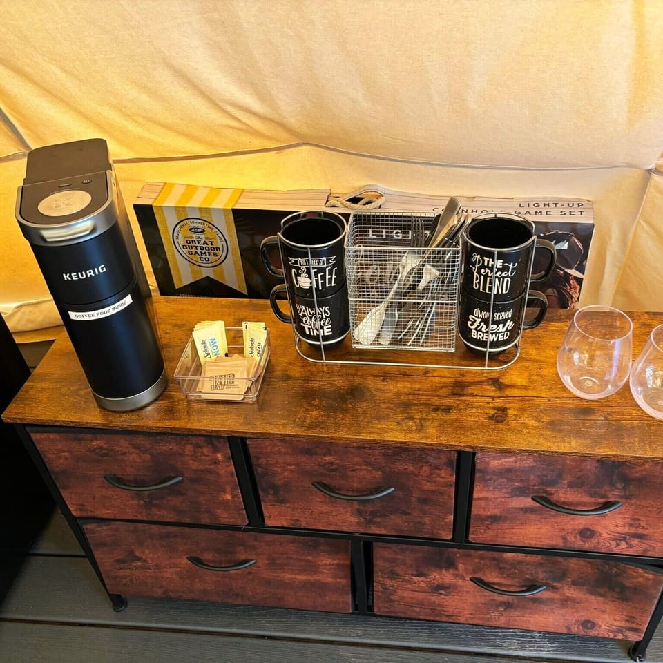 Keurig Coffee maker, coffee pods, creamer and sugars. And a Cornhole Game!