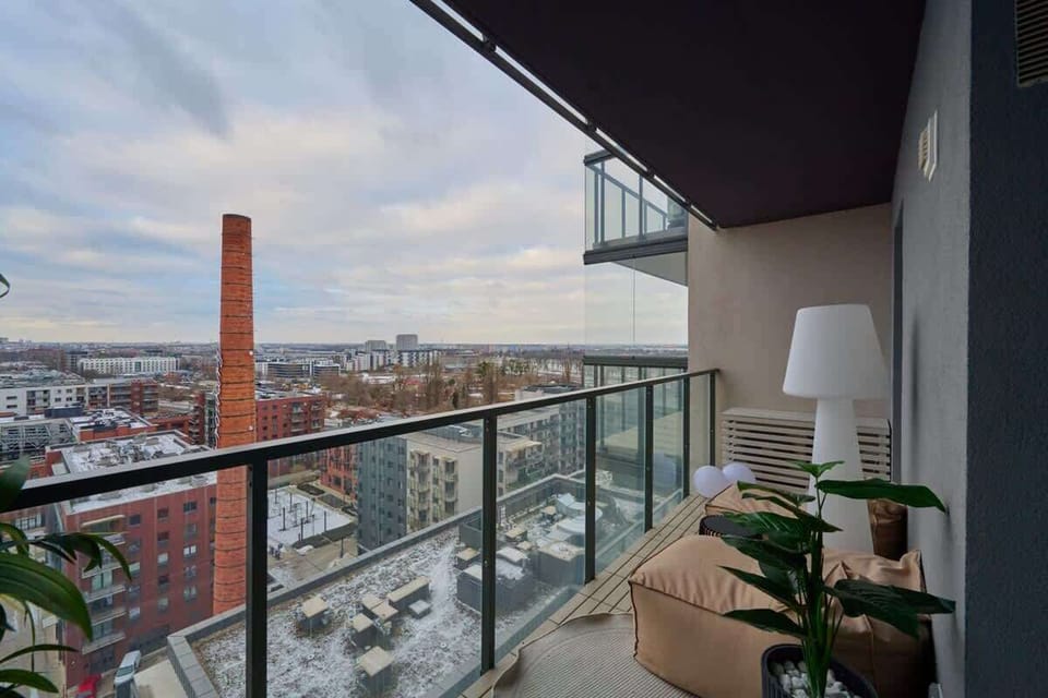 Balcony with cityscape view and outdoor lighting for evening ambiance.
