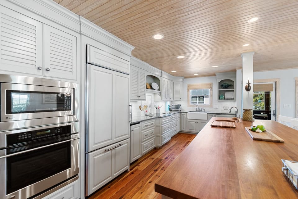 Your gourmet kitchen awaits with premium appliances, spacious island, and warm wood accents for memorable meal preparations.