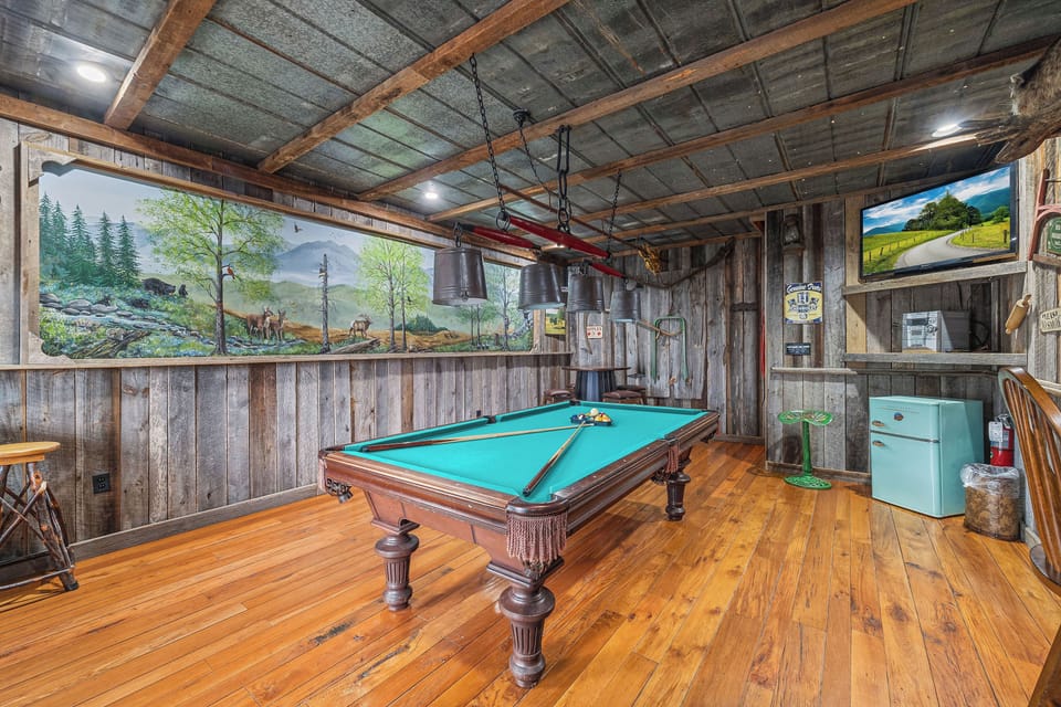 Game Room with pool table, TV, and mini fridge