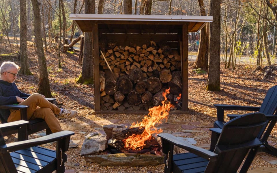 Firepit with complementary firewood and modern Adirondack chairs for your comfort. | Vacayzy