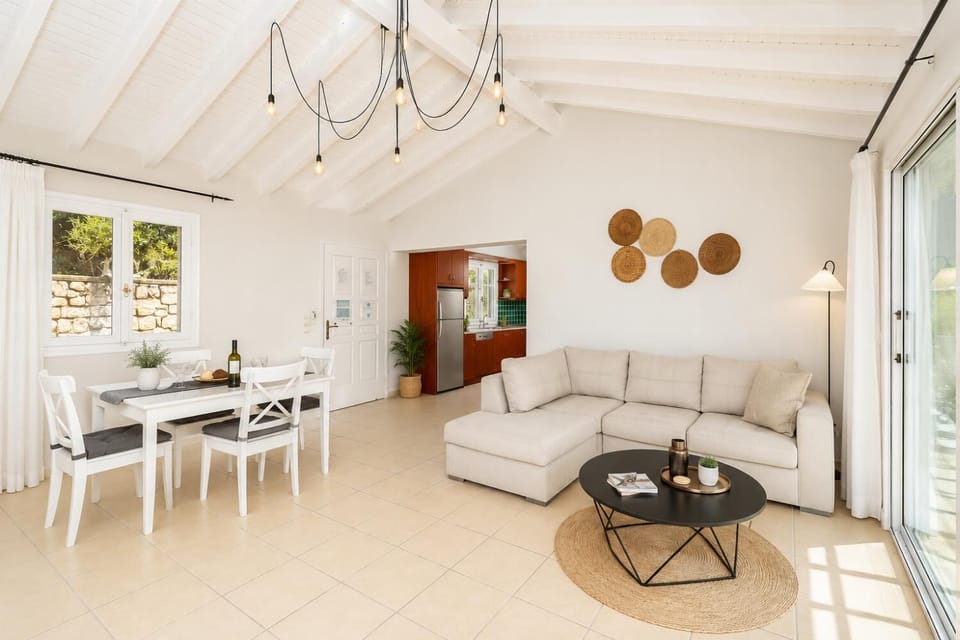 Open-plan living room with sofa, dining area, kitchen, A/C, WiFi internet, satellite TV, and sea views