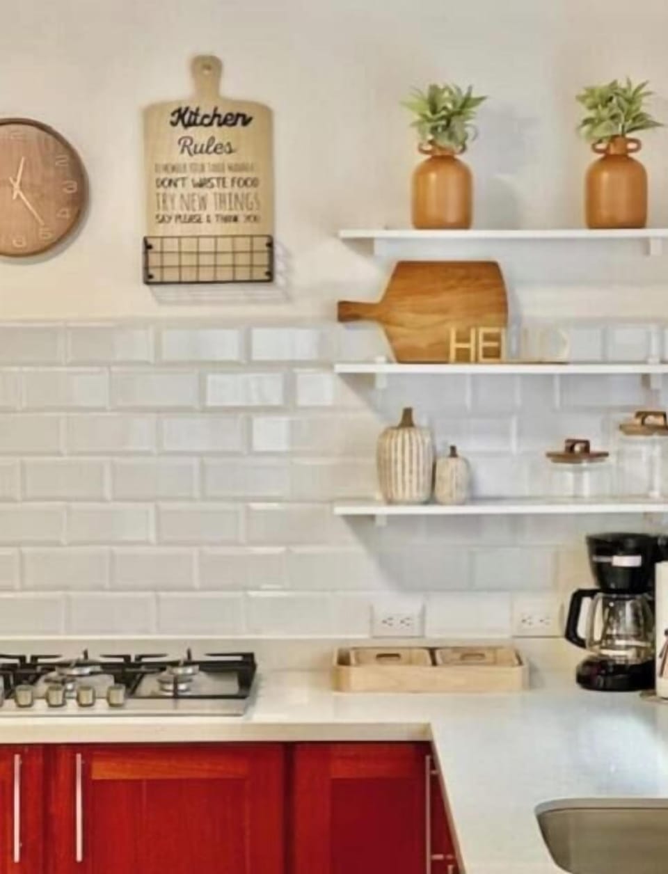 Kitchen with gas stove, microwave, coffee maker and other amenities