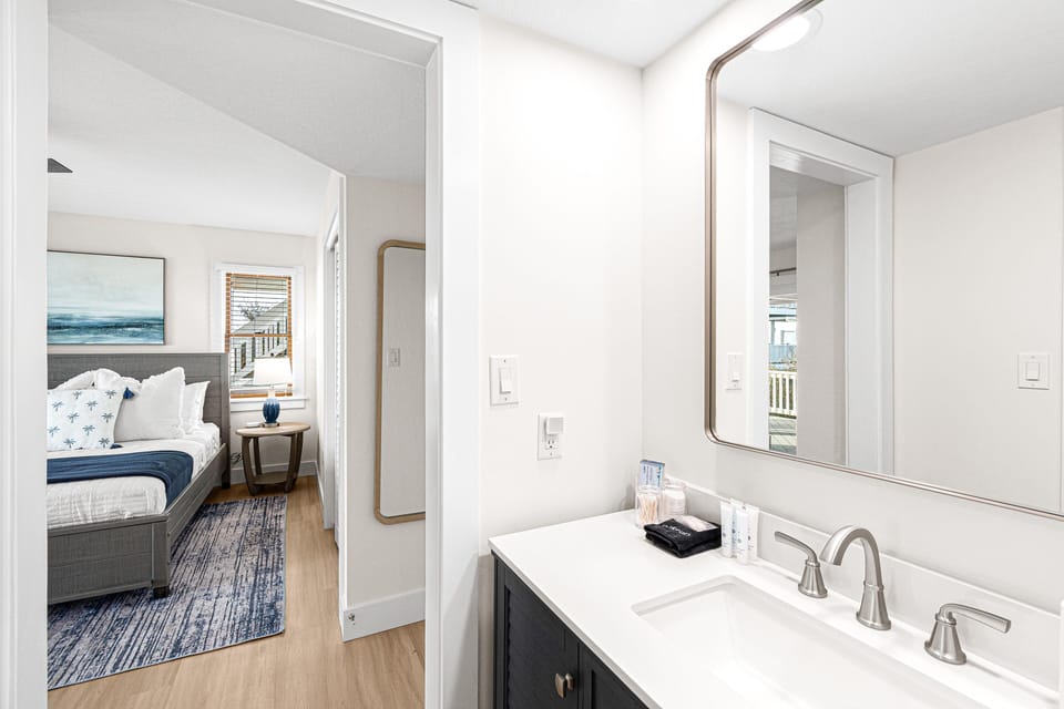 Stylish bathroom connected to a bedroom with a calming color scheme.