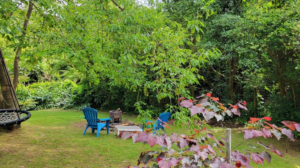 Fire pit, garden seating and swing in the back garden