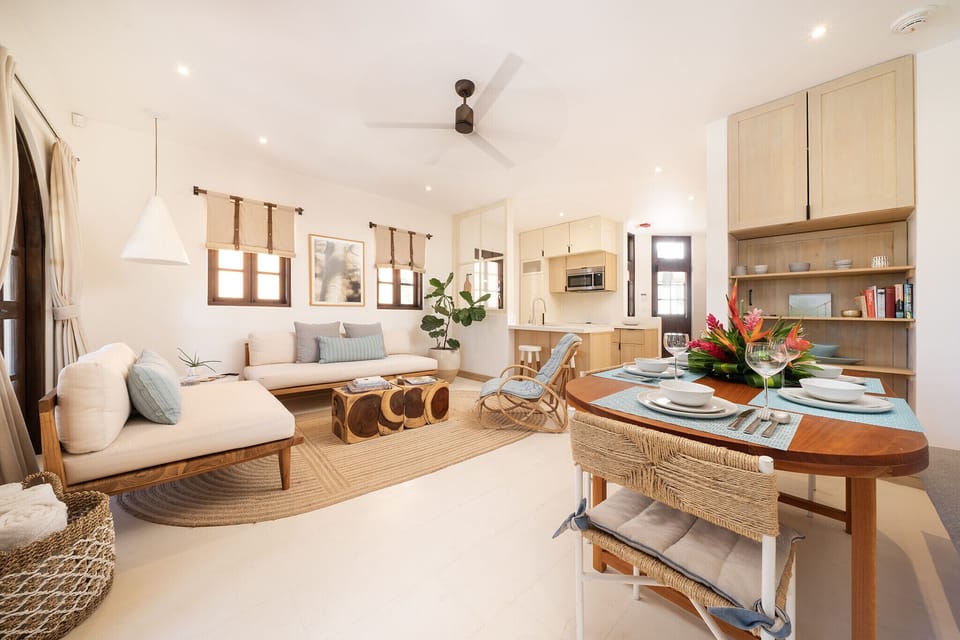 Open-concept living room with dining area and connected kitchen in the background
