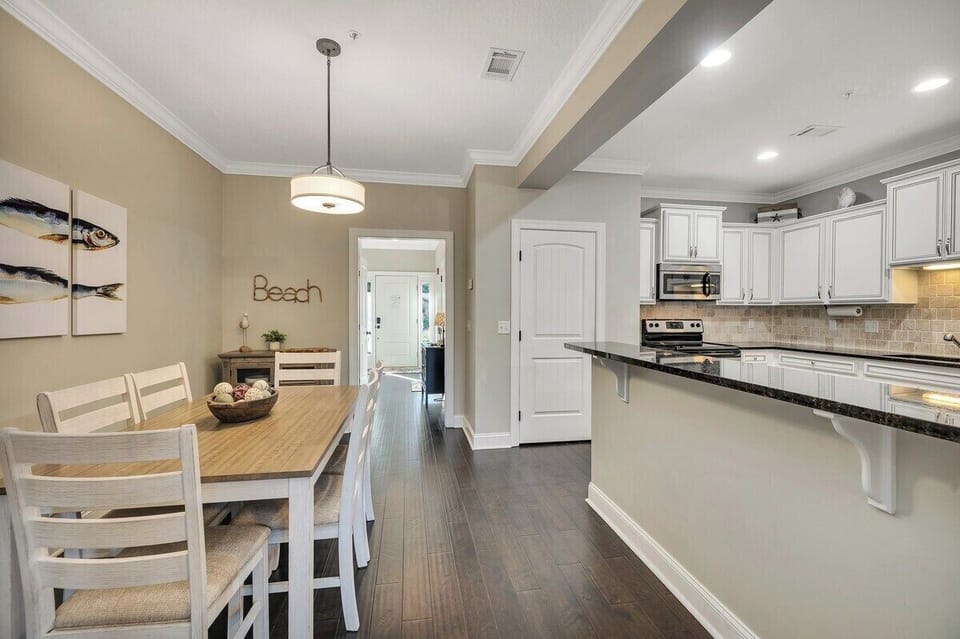 Dining area with wood table and view to kitchen