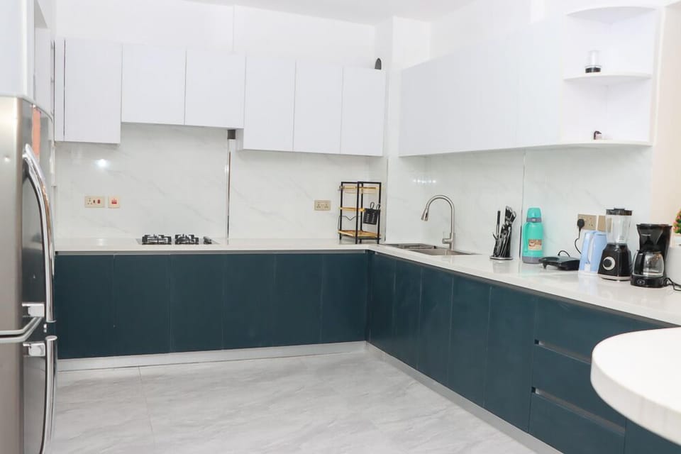 Comfort Apartment | Private kitchen | Fridge, microwave, cookware/dishes/utensils, dining tables