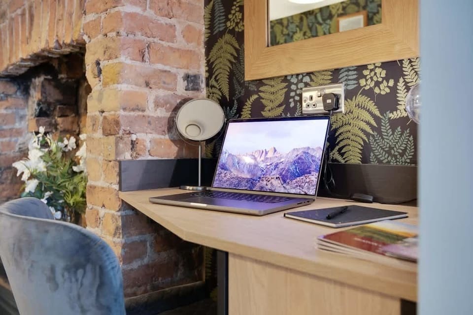 Bedroom 1 offers flexibility and comfort with a cosy double bed and a dedicated workspace area, ensuring a restful retreat for a peaceful night's sleep.