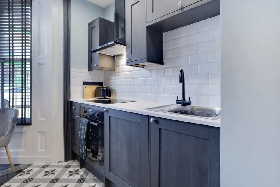Kitchen equipped with all essentials, including a washer & dryer, oven, fridge and full cookware set.