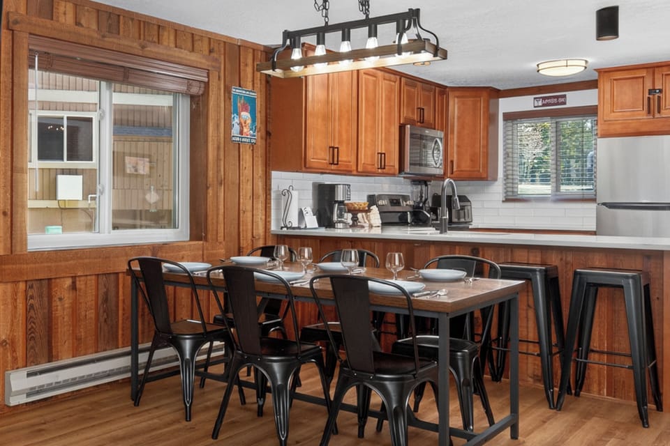 Gather around the spacious dining table where you'll create lasting memories over home-cooked meals in this beautifully appointed kitchen.