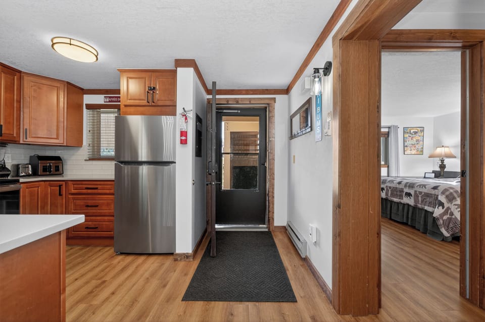 Step into your spacious home-away-from-home featuring a fully equipped kitchen with stainless steel appliances and cozy bedroom.