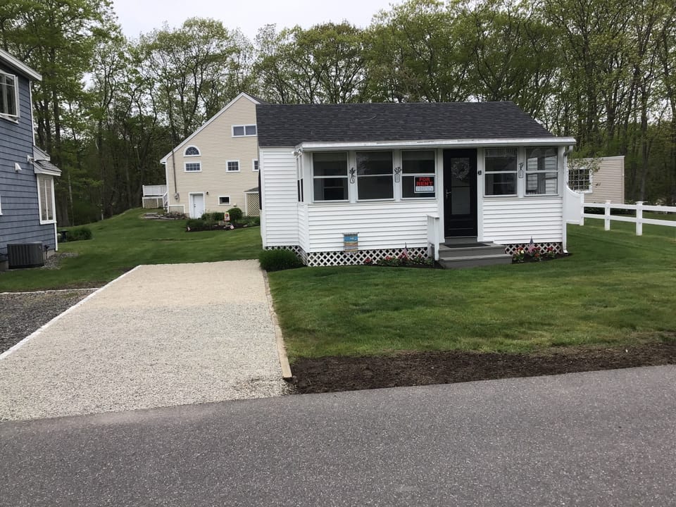 Front of house with 2 tandem parking spaces.