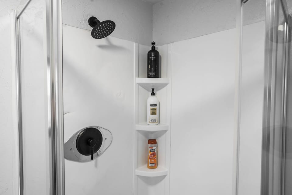 Modern, thoughtfully stocked bathroom with a walk-in shower and simple, functional design—perfect for a quick refresh or a relaxing reset.