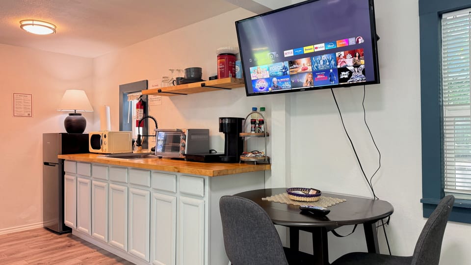 Stream your favorite shows or enjoy a casual bite at the two-person dining table beside the window.

