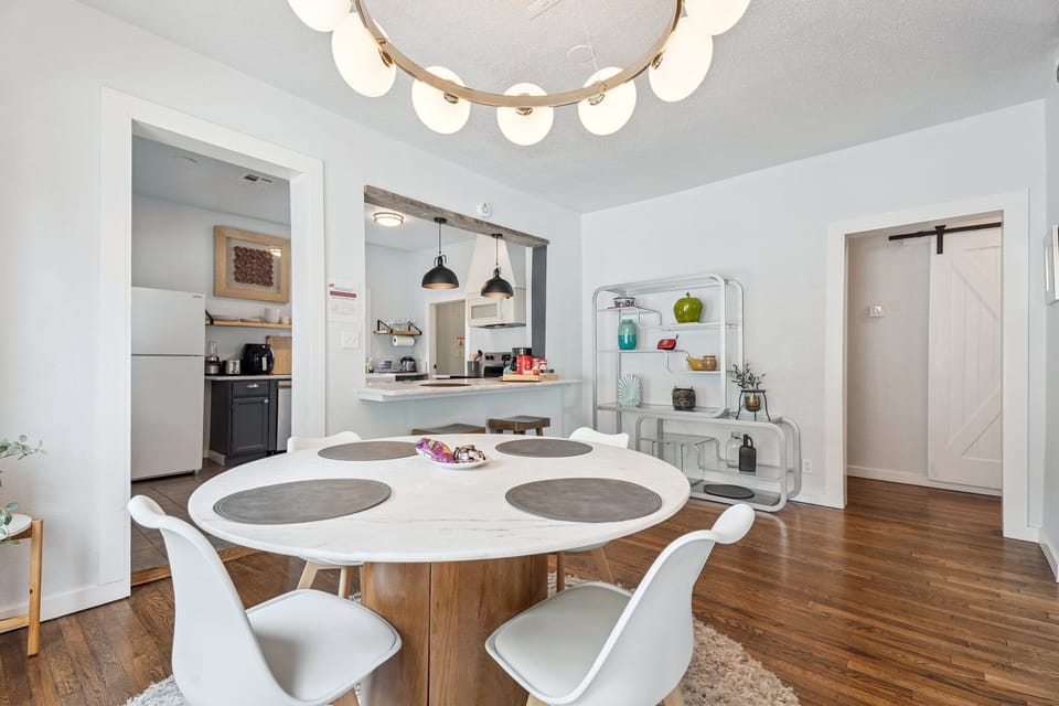 
Mid-century curves meet farmhouse charm—this bright dining area sets the tone for relaxed, stylish stay
