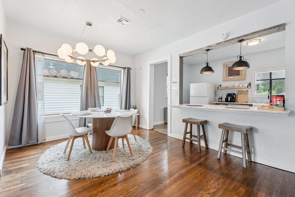 Gather around the cozy dining nook for meals or board games, with natural light pouring in from oversized windows.