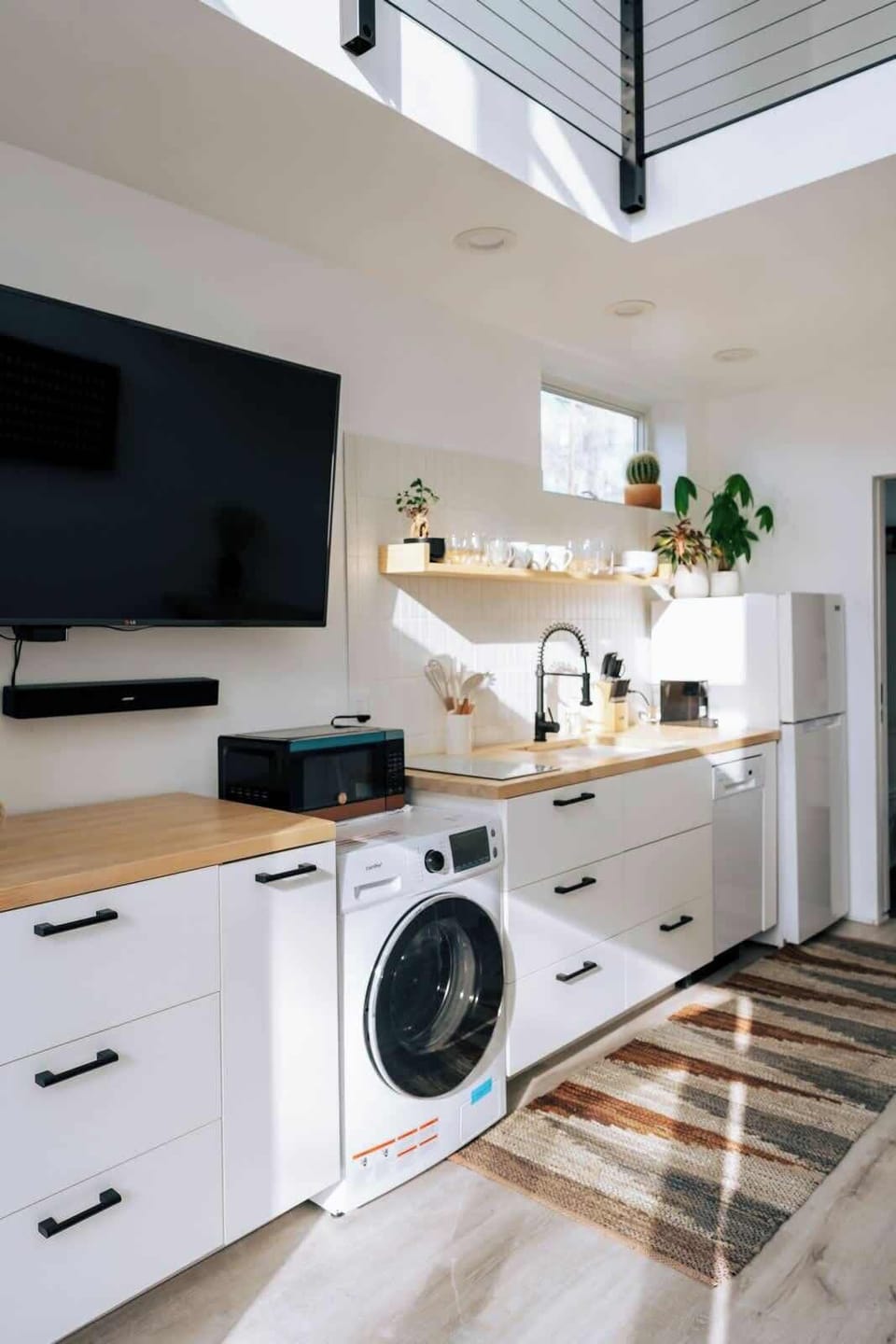 Wake up to the warm and inviting glow of this sun-filled kitchenette, fully stocked with all the essentials. 

We've installed a european-style washer and dryer combo to accommodate guests who might be staying long term.