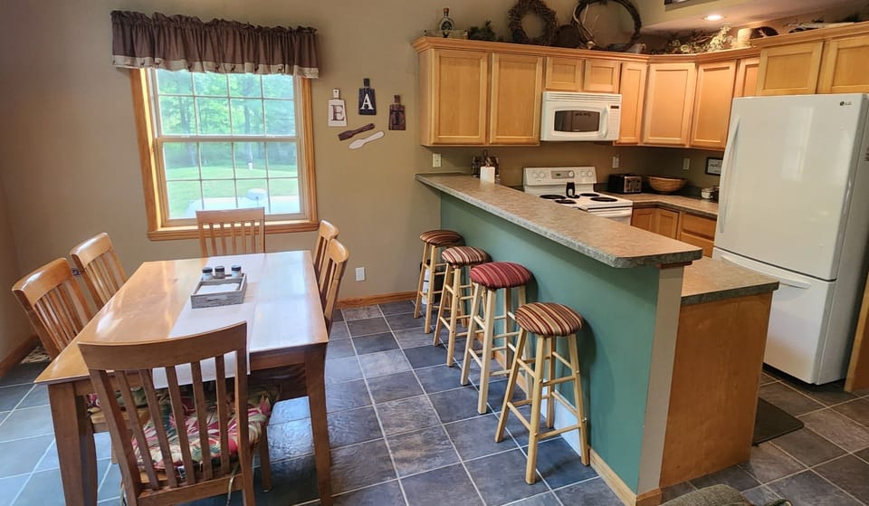 Fully equipped kitchen with appliances, cookware, and all utensils.