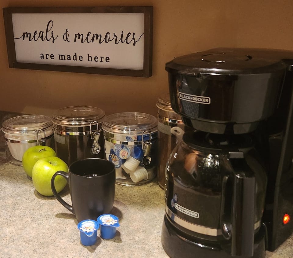 Coffee maker, filters, coffee and creamer included.