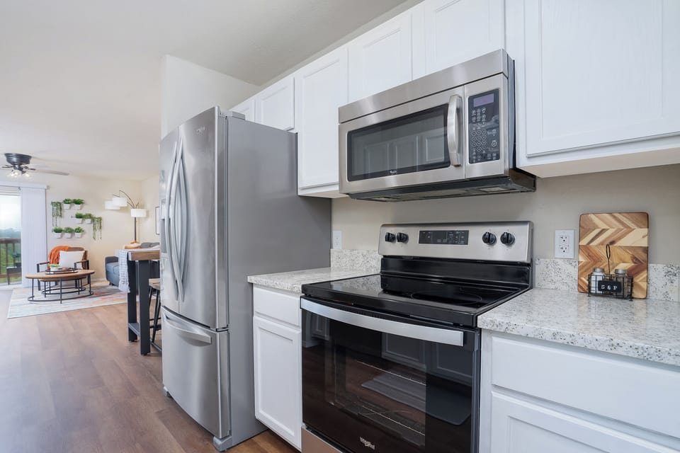 A perfect blend of natural beauty and contemporary design in this kitchen with wooden floors and a black island.