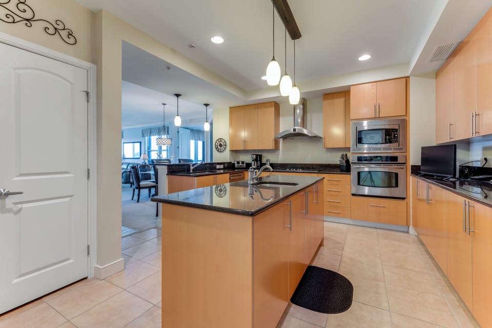 Large gourmet kitchen with solid surface cooktop, oven, microwave & pantry