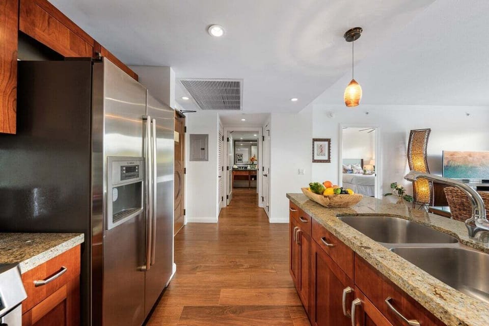 Full kitchen with granite countertops, stainless steel appliances, and pendant lighting