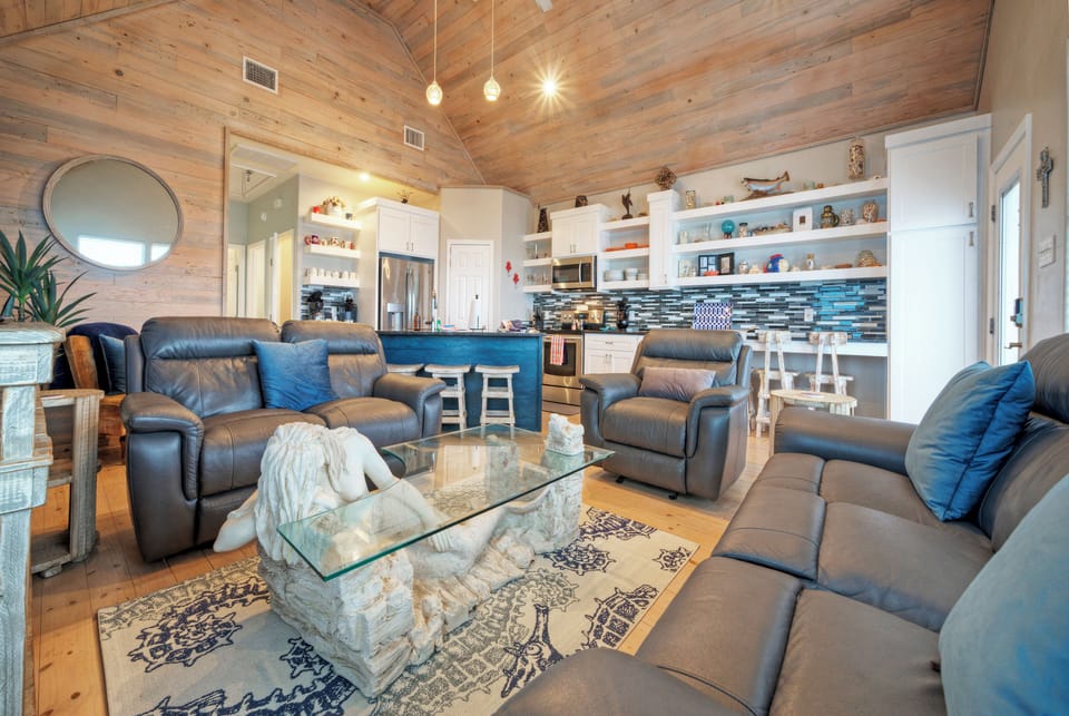Open floor plan features rustic light wood and coastal accents.