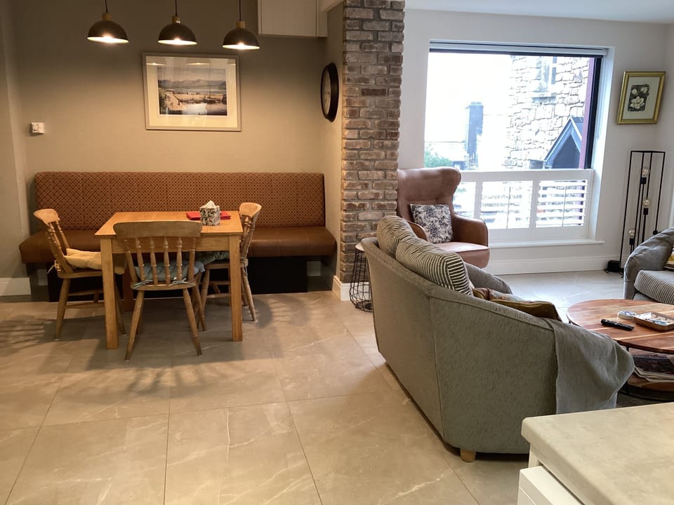 Dining and seating area with panoramic view of twelve bens and harbour