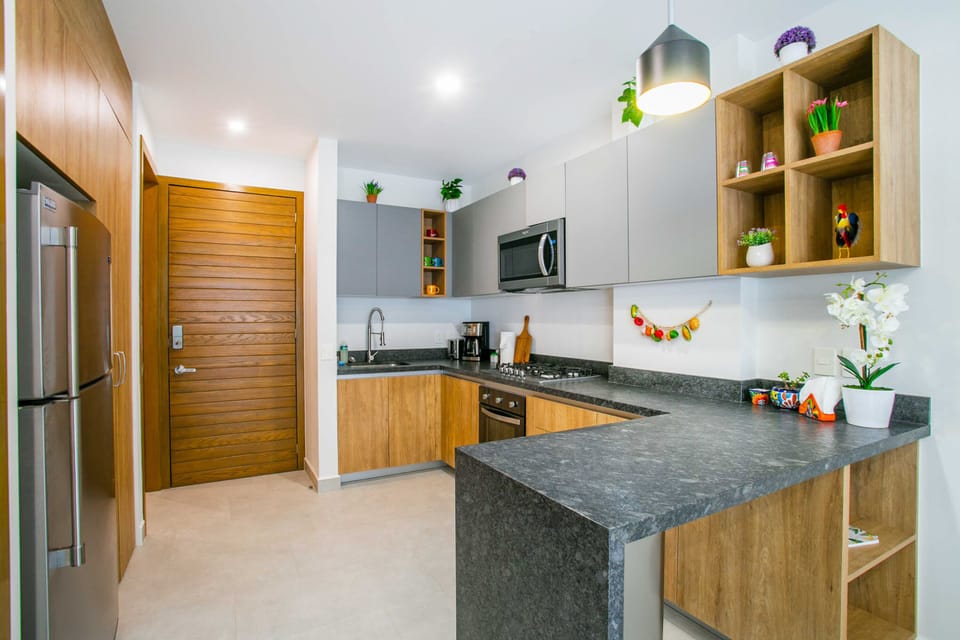 The kitchen is spacious and features amenities like a full-size fridge, stove, oven and microwave