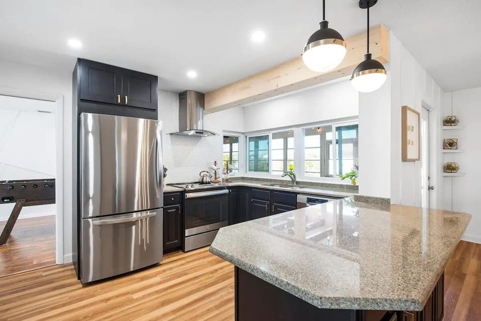 Kitchen stocked with all of your needs - window opens up to barstools in sunroom
